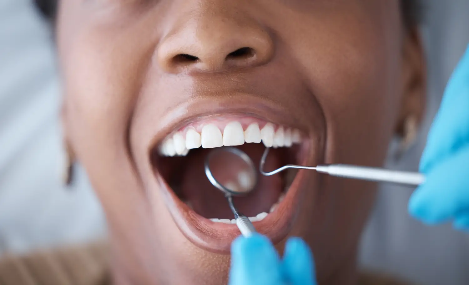 Dentist practicing oral cancer screening