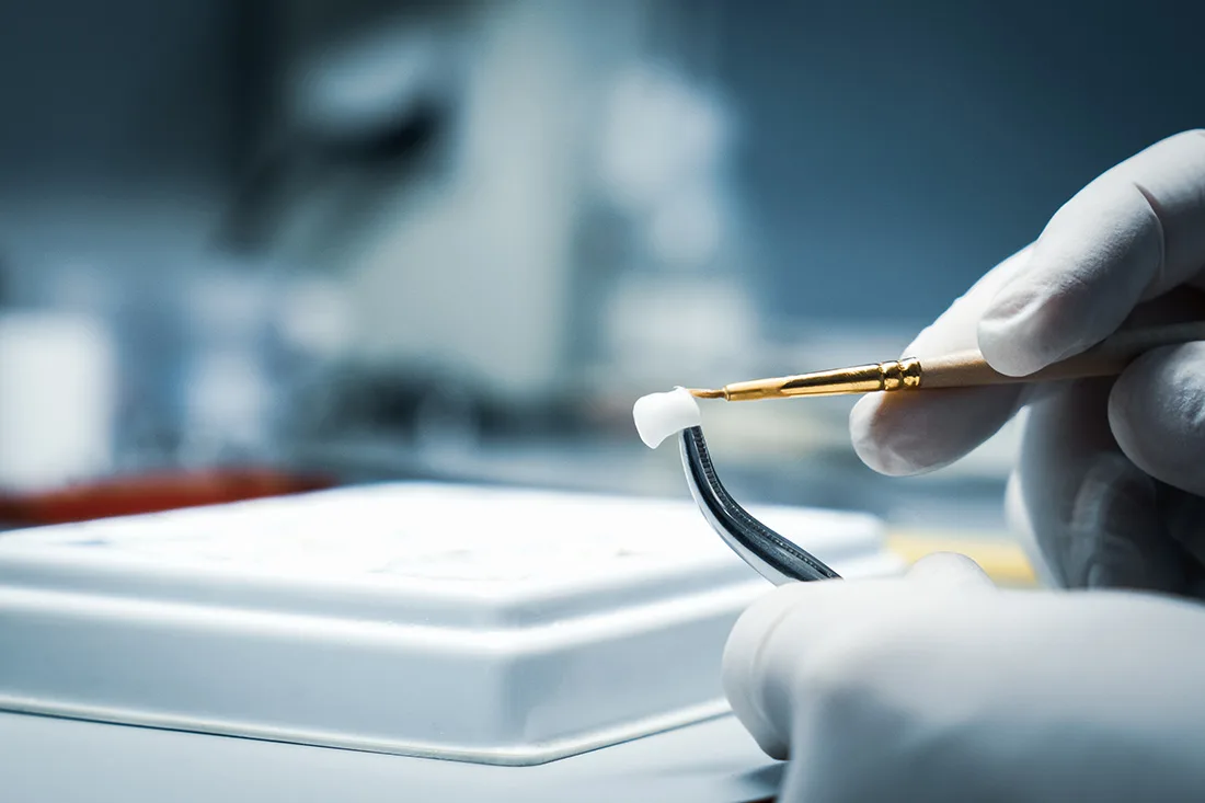 Dentist preparing dental crown