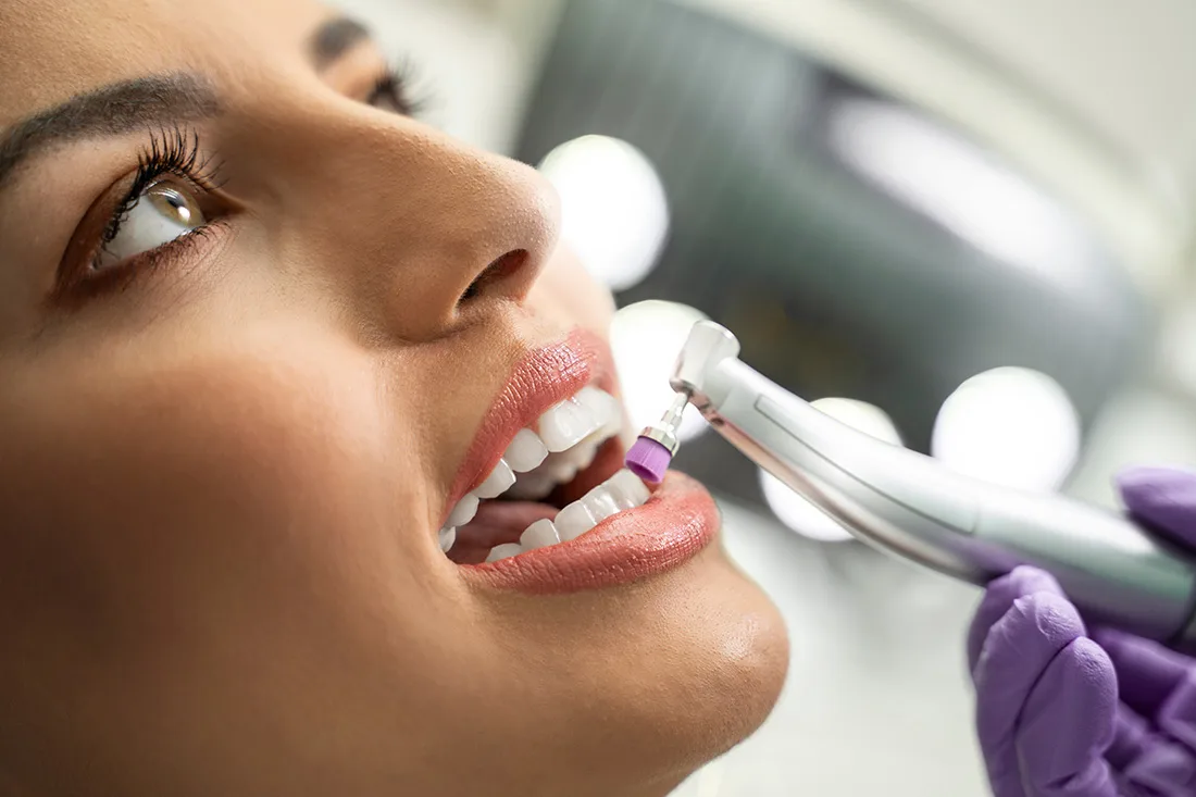 Patient receiving tooth polishing